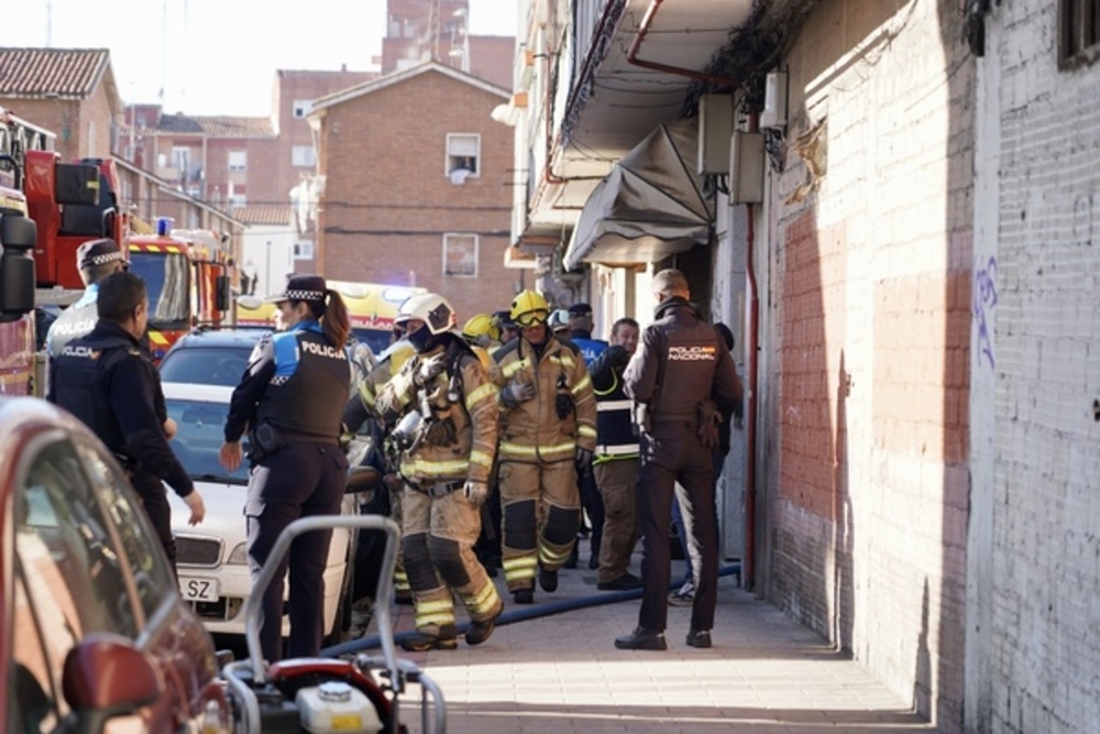 Un grupo de bomberos entra en el edificio. 